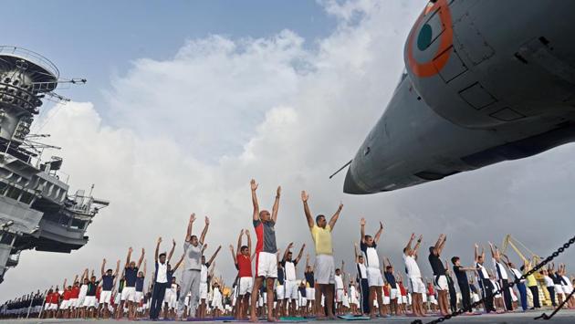 Indian Navy personnel participate in a yoga session to mark International Yoga Day on the Indian aircraft carrier INS Viraat, in Mumbai. (Satyabrata Tripathy / HT Photo) Indian Navy personnel participate in a yoga session to mark International Yoga Day on the Indian aircraft carrier INS Viraat, in Mumbai. (Satyabrata Tripathy / HT Photo)