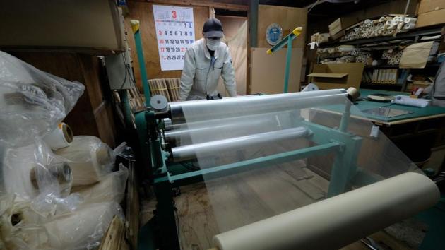 A worker checking a roll of the world's thinnest "washi" paper. Using both machines and hand-made techniques passed down for generations, the firm creates ultra-thin paper, which is also used by conservationists to restore and protect cultural objects. The volume of washi used for restoration is still small, but it’s been shipped to more than 40 countries and Chinzei is hopeful interest will grow. (Kazuhiro NOGI / AFP)
