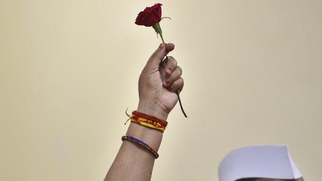 A Congress party supporter holds up a rose as she waits for Indian National Congress President Rahul Gandhi's arrival during his 49th birthday celebrations, at party headquarters, in New Delhi. (Burhaan Kinu / HT Photo) A Congress party supporter holds up a rose as she waits for Indian National Congress President Rahul Gandhi's arrival during his 49th birthday celebrations, at party headquarters, in New Delhi. (Burhaan Kinu / HT Photo)