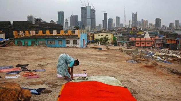 A woman puts clothes to dry overlooking central Mumbai's financial district skyline in Maharashtra. (Francis Mascarenhas / REUTERS) A woman puts clothes to dry overlooking central Mumbai's financial district skyline in Maharashtra. (Francis Mascarenhas / REUTERS)