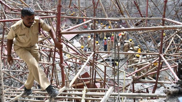 A rescue personnel from Karnataka Fire Services comes out of the rubble after an under construction water tank collapsed in Bangalore, Karnataka. Three workers were killed and over 20 injured when the water tank of the Bangalore Water Supply and Sewerage Board (BWSSB) collapsed. (Manjunath Kiran / AFP) A rescue personnel from Karnataka Fire Services comes out of the rubble after an under construction water tank collapsed in Bangalore, Karnataka. Three workers were killed and over 20 injured when the water tank of the Bangalore Water Supply and Sewerage Board (BWSSB) collapsed. (Manjunath Kiran / AFP)