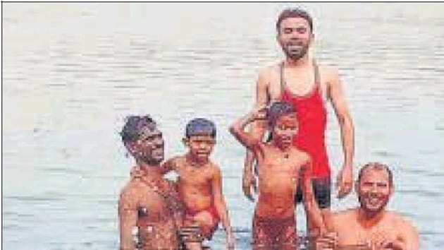 Hitesh Varshney (in red vest) minutes before he drowned in the Yamuna, in Mathura on Saturday. Hitesh Varshney (in red vest) minutes before he drowned in the Yamuna, in Mathura on Saturday.