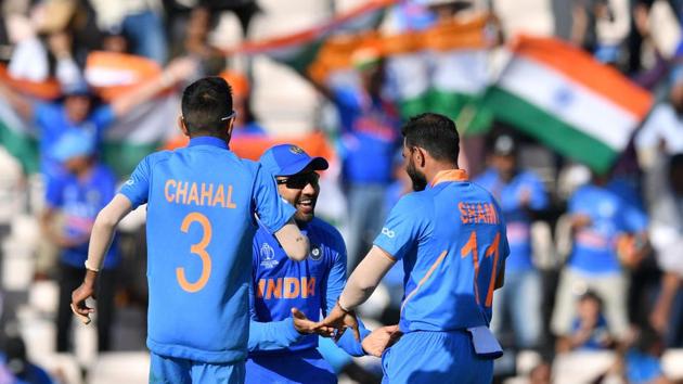 India's Mohammed Shami (R) celebrates with teammates Rohit Sharma (C) and Yuzvendra Chahal (L) after his hat-trick and victory in the 2019 Cricket World Cup group stage match between India and Afghanistan at the Rose Bowl in Southampton, southern England, on June 22, 2019(AFP)