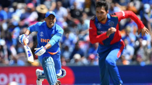 India's Mahendra Singh Dhoni (L) runs between the wickets. (AFP)