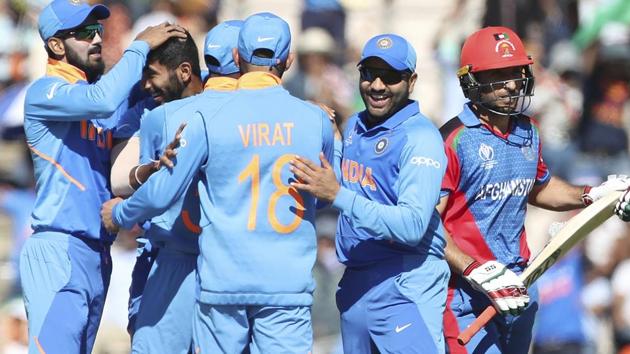 India's Jasprit Bumrah, second left, celebrates with teammates the dismissal of Afghanistan's Rahmat Shah. (AP)