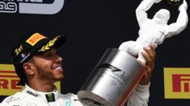 Winner Mercedes' British driver Lewis Hamilton (L) celebrates with his trophy on the podium next to third placed Ferrari's Monegasque driver Charles Leclerc after the Formula One Grand Prix de France at the Circuit Paul Ricard in Le Castellet, southern France, on June 23, 2019. (Photo by Boris HORVAT / AFP)(AFP) Winner Mercedes' British driver Lewis Hamilton (L) celebrates with his trophy on the podium next to third placed Ferrari's Monegasque driver Charles Leclerc after the Formula One Grand Prix de France at the Circuit Paul Ricard in Le Castellet, southern France, on June 23, 2019. (Photo by Boris HORVAT / AFP)(AFP)