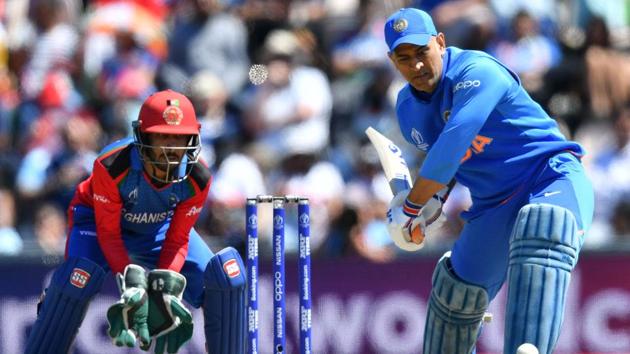 India's Mahendra Singh Dhoni (R) is watched by Afghanistan's Ikram Ali Khil as he plays a shot during the 2019 Cricket World Cup group stage match between India and Afghanistan at the Rose Bowl in Southampton, southern England, on June 22, 2019(AFP)