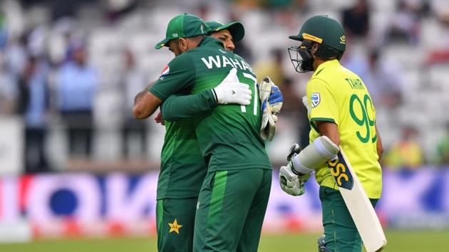 Pakistan's captain Sarfaraz Ahmed (C) embraces teammate Pakistan's Wahab Riaz (L) while South Africa's Imran Tahir (R) looks on as he celebrates with his players after victory in the 2019 Cricket World Cup group stage match between Pakistan and South Africa at Lord's Cricket Ground in London on June 23, 2019(AFP)