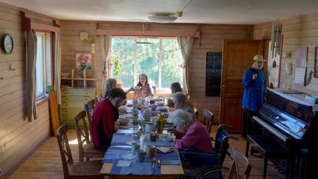 Natasha serves lunch to residents. At Svetlana, residents with various types of learning disabilities including Down syndrome lead an outdoorsy life on the farm, with help from five teachers and three volunteers. In sharp contrast to conditions in state-run homes, they live together in spacious houses, where they have separate bedrooms and share living rooms, dining rooms and kitchens. (Olga Maltseva / AFP)