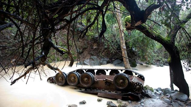 A Syrian tank lies turned over in the Hermon Stream in the Banias Nature Reserve on the western edge of the Golan Heights. Israel captured the area, a former demilitarized zone, in the Six Day War. Today, Israeli tourists carve graffiti into the metal of the tank while dangling their feet in the foaming water below. “It’s surrealistic,” said Daniel Alonim, 54, as his friends played Scrabble atop the hulk. “Like it fell from space.” (Ronen Zvulun / REUTERS) A Syrian tank lies turned over in the Hermon Stream in the Banias Nature Reserve on the western edge of the Golan Heights. Israel captured the area, a former demilitarized zone, in the Six Day War. Today, Israeli tourists carve graffiti into the metal of the tank while dangling their feet in the foaming water below. “It’s surrealistic,” said Daniel Alonim, 54, as his friends played Scrabble atop the hulk. “Like it fell from space.” (Ronen Zvulun / REUTERS)