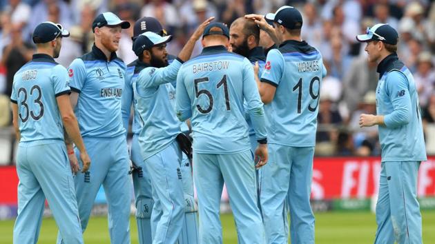England's players celebrate after the dismissal of Australia's David Warner. (AFP)