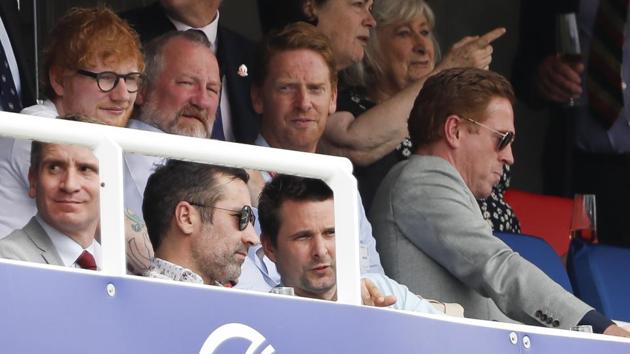 British singer songwriter Ed Sheeran, left watches the Cricket World Cup match between England and Australia.(AP)