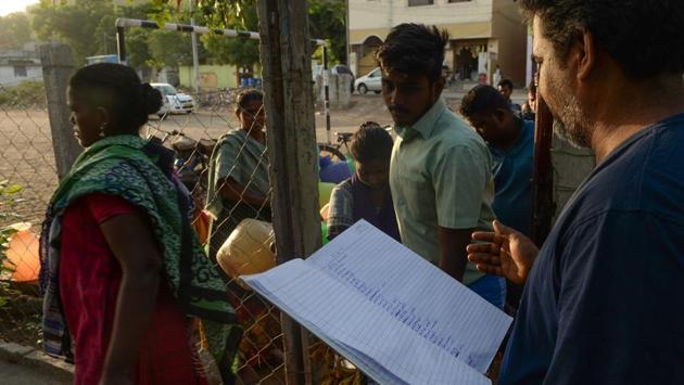 A man holds lists of names and numbers after residents picked lots to draw water. The lucky first-comers get clear, fresh water. Those at the end get an earth-coloured liquid.Srinivasan said he waits about five hours each day in water queues and spends around 2,000 rupees a month from his 15,000-rupee monthly salary on bottled water or paying for a tanker truck to deliver water. (Arun Sankar / AFP) A man holds lists of names and numbers after residents picked lots to draw water. The lucky first-comers get clear, fresh water. Those at the end get an earth-coloured liquid.Srinivasan said he waits about five hours each day in water queues and spends around 2,000 rupees a month from his 15,000-rupee monthly salary on bottled water or paying for a tanker truck to deliver water. (Arun Sankar / AFP)