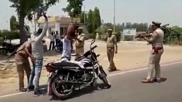 In a video that has gone viral on social media, police in Badaun were seen making people hold up their hands at gun point while they checked vehicles. SSP of Badaun Ashok Kumar Tripathi said, “The way people were checked is not a norm. It was done by the our personnel as a drill so that they could respond efficiently if a person they are checking turns out be criminal.” (ANI)