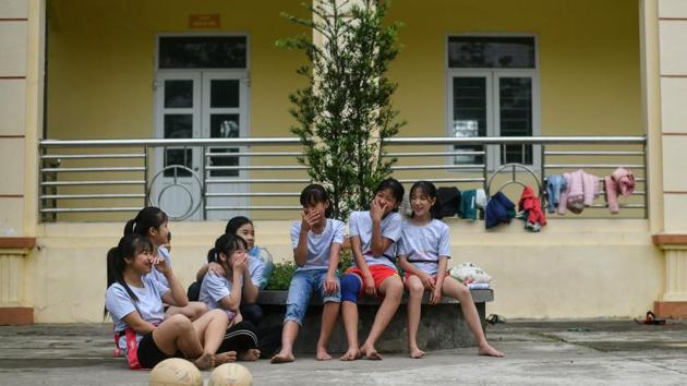 Girls taking a break during a rugby clinic. The game isn’t totally unfamiliar either, as it echoes aspects of the traditional “vat cau” new year festival that sees shirtless men wrestle for possession of a large wooden ball on a field. Now Vietnam’s budding young rugby stars hope the sport will start to gain popularity and participates in the Rugby World Cup one day. (Manan Vaytsyayana / AFP) Girls taking a break during a rugby clinic. The game isn’t totally unfamiliar either, as it echoes aspects of the traditional “vat cau” new year festival that sees shirtless men wrestle for possession of a large wooden ball on a field. Now Vietnam’s budding young rugby stars hope the sport will start to gain popularity and participates in the Rugby World Cup one day. (Manan Vaytsyayana / AFP)