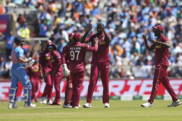 West Indies' captain Jason Holder, second right, celebrates after taking the wicket of India's captain Virat Kohli. (AP)