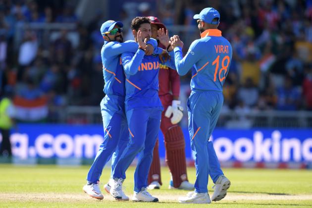 India's Kuldeep Yadav (C) celebrates with teammates after taking the wicket of West Indies' Nicholas Pooran for 28 (AFP)