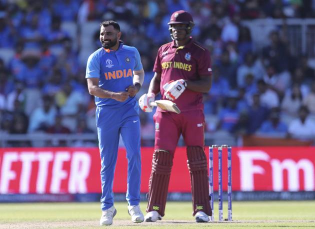 India's Mohammed Shami, left, celebrates the dismissal of West Indies' Oshane Thomas (AP)