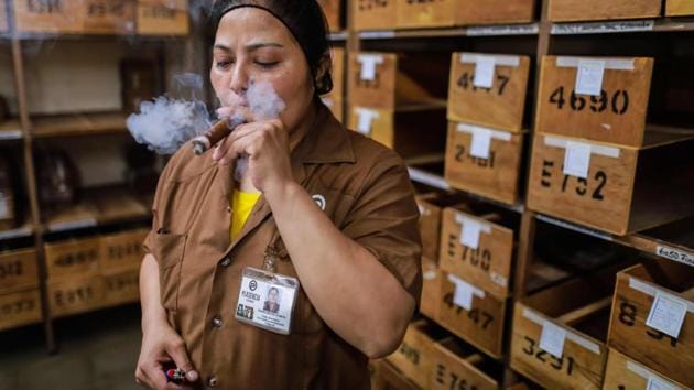 Karina Rivera, a quality control supervisor at Plasencia Cigars, tests an average of eight cigars a day. “If I see that it’s not at the level of quality demanded by customers, we report immediately to find out where the problem is,” she said. (Inti Ocon / AFP)