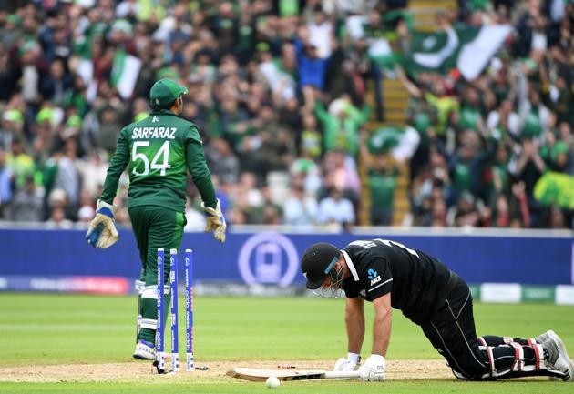 TOPSHOT - New Zealand's Colin de Grandhomme (R) reacts after being run out as Pakistan's captain Sarfaraz Ahmed walks past. (AFP) TOPSHOT - New Zealand's Colin de Grandhomme (R) reacts after being run out as Pakistan's captain Sarfaraz Ahmed walks past. (AFP)
