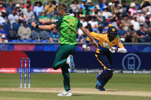 South Africa's Chris Morris (L) gestures as Sri Lanka's Isuru Udana runs between wickets. (AFP) 