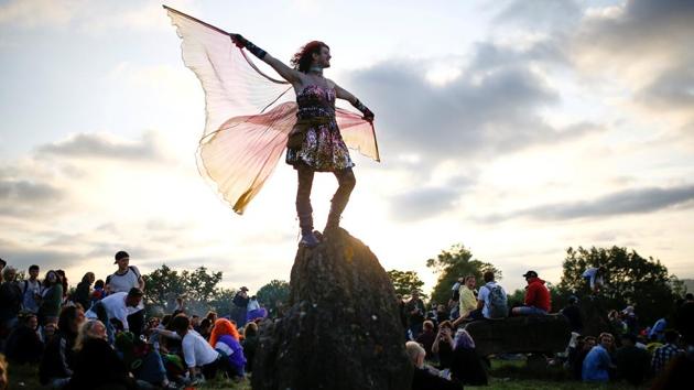 A festival goer dances during sunset at the stone circle during Glastonbury Festival at Worthy farm in Somerset, England. (Henry Nicholls / REUTERS) A festival goer dances during sunset at the stone circle during Glastonbury Festival at Worthy farm in Somerset, England. (Henry Nicholls / REUTERS)