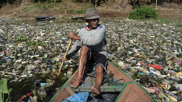 A scavenger paddles his wooden boat to collect plastic waste for recycling on the Citarum river choked with garbage and industrial waste, in Bandung, West Java province, Indonesia. The river, one of the world’s most polluted after decades of failed clean-up efforts, in 2018 was earmarked for revitalisation by Jakarta to make its water drinkable again by 2025. (Timur Matahari / AFP) A scavenger paddles his wooden boat to collect plastic waste for recycling on the Citarum river choked with garbage and industrial waste, in Bandung, West Java province, Indonesia. The river, one of the world’s most polluted after decades of failed clean-up efforts, in 2018 was earmarked for revitalisation by Jakarta to make its water drinkable again by 2025. (Timur Matahari / AFP)