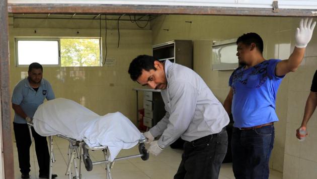 The body of Oscar Alberto Martinez Ramirez, coming out of the morgue in Matamoros. Migrants now face long waits to apply for asylum at the US-Mexican border as US officials enforce a policy of “metering,” which limits the number of people who can apply each day. The controls have contributed to growing numbers crossing the border illegally, instead of applying at ports of entry, further increasing dangers. (Carlos Jasso / REUTERS)