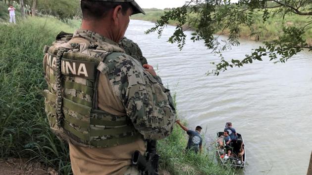 A Mexican marine looks on during a search operation for Oscar and Valeria. The UN refugee agency said the photo of Oscar and Angie Valeria from the US border represents “a failure to address the violence and desperation pushing people to take journeys of danger.” Pope Francis expressed great sorrow upon viewing the image, said the Vatican, whose newspaper published the photograph on its front page. (Alejandro Hernandez / Expreso de Matamoros via REUTERS)