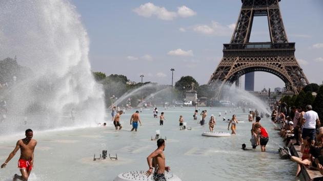 People cool off in the Trocadero fountains across from the Eiffel Tower in Paris as a heatwave hit much of the country, France. REUTERS/Charles Platiau