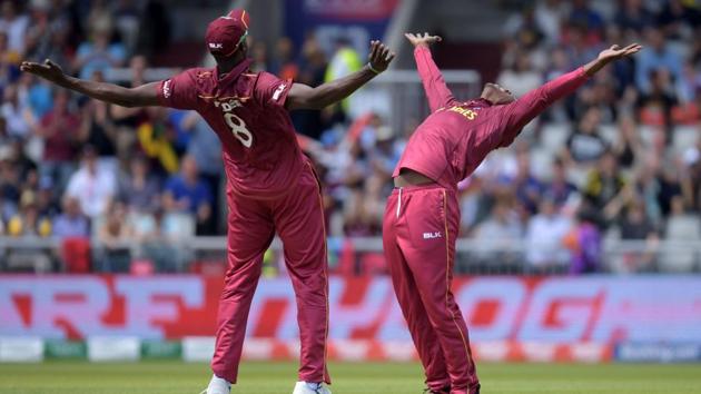 West Indies’ Sheldon Cottrell (R) celebrates with West Indies’ captain Jason Holder after the dismissal of New Zealand’s Colin Munro during the 2019 Cricket World Cup group stage match between West Indies and New Zealand at Old Trafford in Manchester, northwest England. (Dibyangshu Sarkar / AFP) West Indies’ Sheldon Cottrell (R) celebrates with West Indies’ captain Jason Holder after the dismissal of New Zealand’s Colin Munro during the 2019 Cricket World Cup group stage match between West Indies and New Zealand at Old Trafford in Manchester, northwest England. (Dibyangshu Sarkar / AFP)