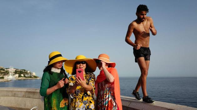 A man walks by as tourists take selfies on the French Riviera city of Nice, France as temperatures soar to 33 degrees Celsius. Forecasters say Europeans will feel sizzling heat this week with temperatures soaring as high as 40 degrees Celsius in an “unprecedented” June heatwave hitting much of Western Europe. (Valery Hache / AFP) A man walks by as tourists take selfies on the French Riviera city of Nice, France as temperatures soar to 33 degrees Celsius. Forecasters say Europeans will feel sizzling heat this week with temperatures soaring as high as 40 degrees Celsius in an “unprecedented” June heatwave hitting much of Western Europe. (Valery Hache / AFP)