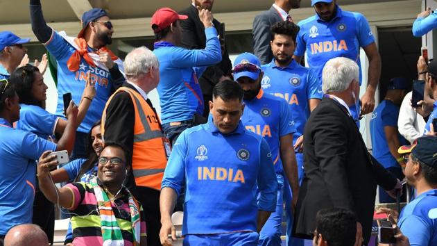 India's Mahendra Singh Dhoni (C) walks out onto the field ahead of the 2019 Cricket World Cup group stage match between India and Afghanistan at the Rose Bowl in Southampton, southern England, on June 22, 2019.(AFP)