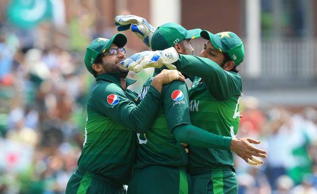 Pakistan's Mohammad Amir (C) celebrates with teammate Imam-ul-Haq (L) and captain Sarfaraz Ahmed (R) after taking a catch for the dismissal of Afghanistan's Mohammad Nabi. (AFP)
