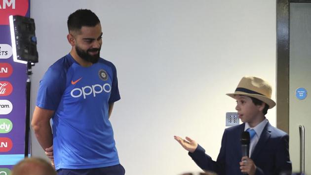 Nine-year old Edward William, right, introduces India's captain Virat Kohli, left, to journalists as part of a fundraising event OneDay4Children before the press conference.(AP)