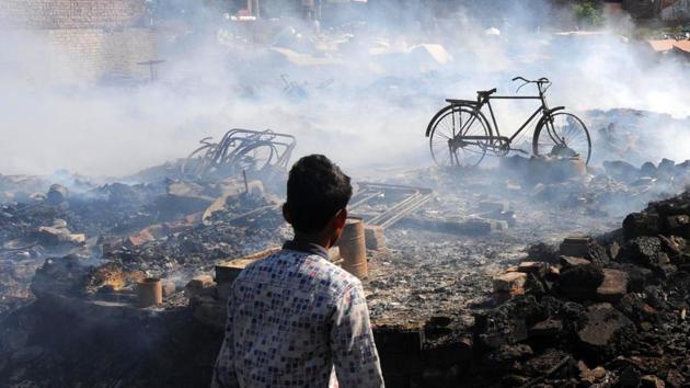 A boy looks at the smouldering remains of hutments which were burnt in a fire at Chamrang Road in Amritsar, Punjab. (ANI) A boy looks at the smouldering remains of hutments which were burnt in a fire at Chamrang Road in Amritsar, Punjab. (ANI)