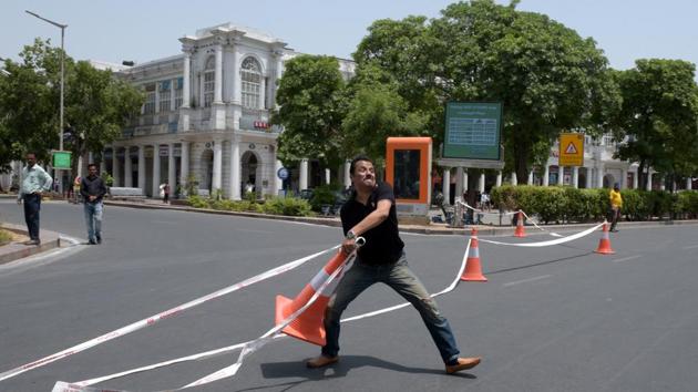 A demonstrator disrupts a diversion made from traffic cones during a protest by traders in Delhi’s Connaught Place against the New Delhi Municipal Council (NDMC) over the pedestrianisation of the inner circle, in New Delhi. (Mohd Zakir / HT Photo) A demonstrator disrupts a diversion made from traffic cones during a protest by traders in Delhi’s Connaught Place against the New Delhi Municipal Council (NDMC) over the pedestrianisation of the inner circle, in New Delhi. (Mohd Zakir / HT Photo)