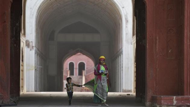 A child holds onto his mother’s sari during restoration work at the Red Fort, in Delhi. One of India’s most iconic monuments, the Red Fort, has received an elaborate facelift over the last year. Close to 400 post-Independence structures have been demolished, and the elegance of Mughal-era structures restored. (Burhaan Kinu / HT Photo) A child holds onto his mother’s sari during restoration work at the Red Fort, in Delhi. One of India’s most iconic monuments, the Red Fort, has received an elaborate facelift over the last year. Close to 400 post-Independence structures have been demolished, and the elegance of Mughal-era structures restored. (Burhaan Kinu / HT Photo)