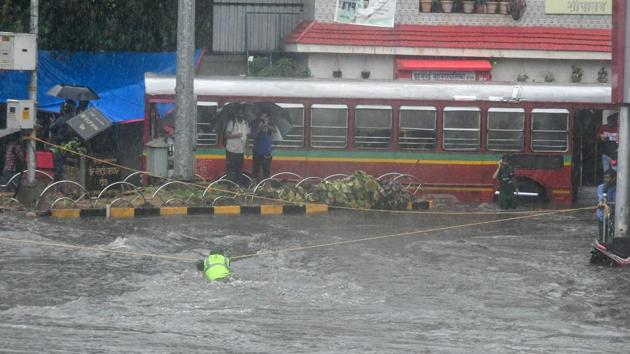 A BMC official ties ropes to indicate the subway, so that people are prevented from walking through it. Heavy rains exposed the ill-preparedness of the city’s authorities, especially the BMC, with water logging complaints pouring in through the day. In rain-related incidents, three people died of electric shocks and five were injured on Friday, while 53 tree-fall incidents were reported in ten hours. (Shashi S Kashyap / HT Photo) A BMC official ties ropes to indicate the subway, so that people are prevented from walking through it. Heavy rains exposed the ill-preparedness of the city’s authorities, especially the BMC, with water logging complaints pouring in through the day. In rain-related incidents, three people died of electric shocks and five were injured on Friday, while 53 tree-fall incidents were reported in ten hours. (Shashi S Kashyap / HT Photo)