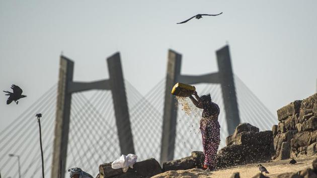 A fisherwoman winnows dust away from prawns laid out to dry at Worli village in Mumbai, Maharashtra. (Pratik Chorge / HT Photo) A fisherwoman winnows dust away from prawns laid out to dry at Worli village in Mumbai, Maharashtra. (Pratik Chorge / HT Photo)