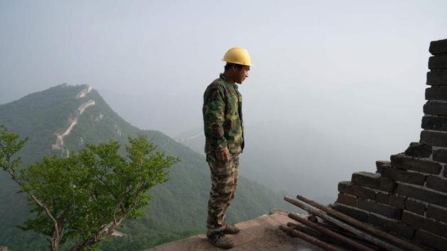 A worker inspecting a restored part of the Great Wall.(AFP) A worker inspecting a restored part of the Great Wall.(AFP)