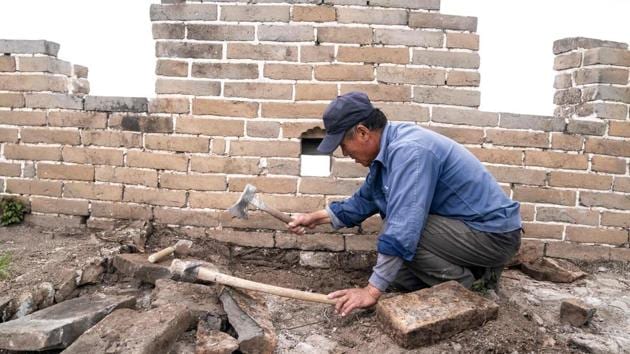 “They are all the bricks that collapsed from the original wall. The bricks are used to mend these places,” said Li Jingdong, one of the workers restoring the Jiankou section. Construction of the Great Wall first began in the third century BC and continued for centuries. Nearly 6,300 kilometres, including the Jiankou section, were built in the Ming Dynasty of 1368-1644. (Fred Dufor / AFP) “They are all the bricks that collapsed from the original wall. The bricks are used to mend these places,” said Li Jingdong, one of the workers restoring the Jiankou section. Construction of the Great Wall first began in the third century BC and continued for centuries. Nearly 6,300 kilometres, including the Jiankou section, were built in the Ming Dynasty of 1368-1644. (Fred Dufor / AFP)