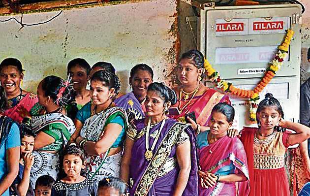 Residents at the inauguration of the first electricity meters at Naushacha Pada, Aarey Colony.(HT Photo)