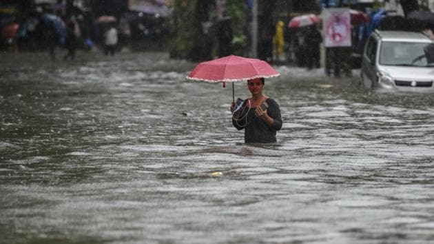 A girl walks along a flooded street after heavy rain showers Gandhi Market, Sion in Mumbai, India, on Monday, July 1, 2019. (Kunal Patil/HT Photo)
