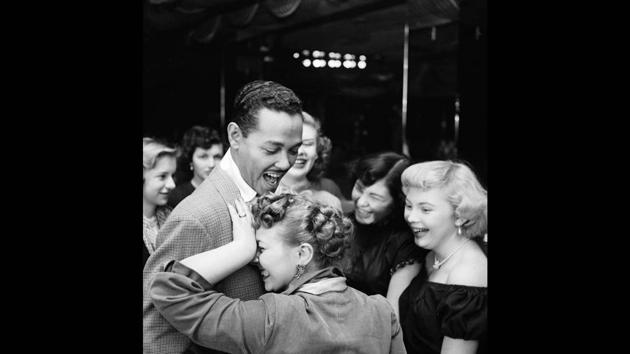 Martha Holmes began photographing for LIFE in 1944, and this one of mixed-race singer Billy Eckstine being embraced by a white fan (from 1950) was a provocative image that Holmes counted among her best because she felt that it “told just what the world should be like.” (© LIFE Picture Collection, Meredith Corporation) Martha Holmes began photographing for LIFE in 1944, and this one of mixed-race singer Billy Eckstine being embraced by a white fan (from 1950) was a provocative image that Holmes counted among her best because she felt that it “told just what the world should be like.” (© LIFE Picture Collection, Meredith Corporation)