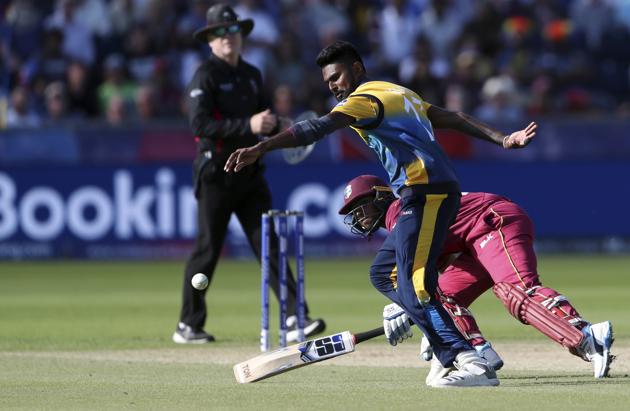 Sri Lanka's bowler Isuru Udana, front, attempts fielding the ball as he collides with West Indies' batsman Nicholas Pooran. (AP) Sri Lanka's bowler Isuru Udana, front, attempts fielding the ball as he collides with West Indies' batsman Nicholas Pooran. (AP)