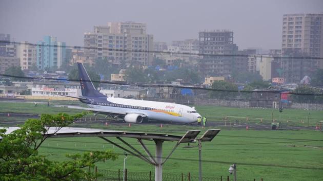 A SpiceJet plane from Jaipur overshot the runway while landing at Mumbai airport amid heavy rain late on Monday night. A 150-metre-ramp is being prepared to help move the SpiceJet plane which is still stuck on the unpaved part towards the end of the main runway number 27 of the airport. It may take up to 48 hours to resume the flight operations on the runway. (Vijayanand Gupta / HT Photo) A SpiceJet plane from Jaipur overshot the runway while landing at Mumbai airport amid heavy rain late on Monday night. A 150-metre-ramp is being prepared to help move the SpiceJet plane which is still stuck on the unpaved part towards the end of the main runway number 27 of the airport. It may take up to 48 hours to resume the flight operations on the runway. (Vijayanand Gupta / HT Photo)