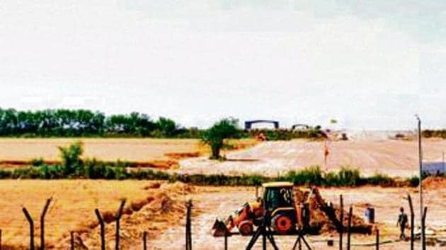 Heavy machines at work beyond the border fence for the construction of the Indian side of Kartarpur corridor, in Gurdaspur(PTI) Heavy machines at work beyond the border fence for the construction of the Indian side of Kartarpur corridor, in Gurdaspur(PTI)