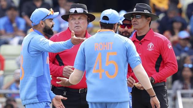 India's captain Virat Kohli, left, speaks with umpires. (AP) India's captain Virat Kohli, left, speaks with umpires. (AP)