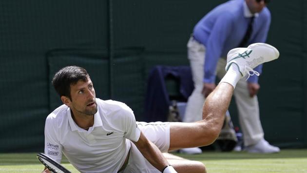 Serbia’s Novak Djokovic falls to the ground as he plays Germany’s Philip Kohlschreiber in a Men’s singles match during day one of the Wimbledon Tennis Championships. The competition kicked off yesterday with Djokovic beginning the defence of his men’s singles title on Centre Court at 1pm with a 6-3, 7-5, 6-3 sweep. (Kirsty Wigglesworth / AP)